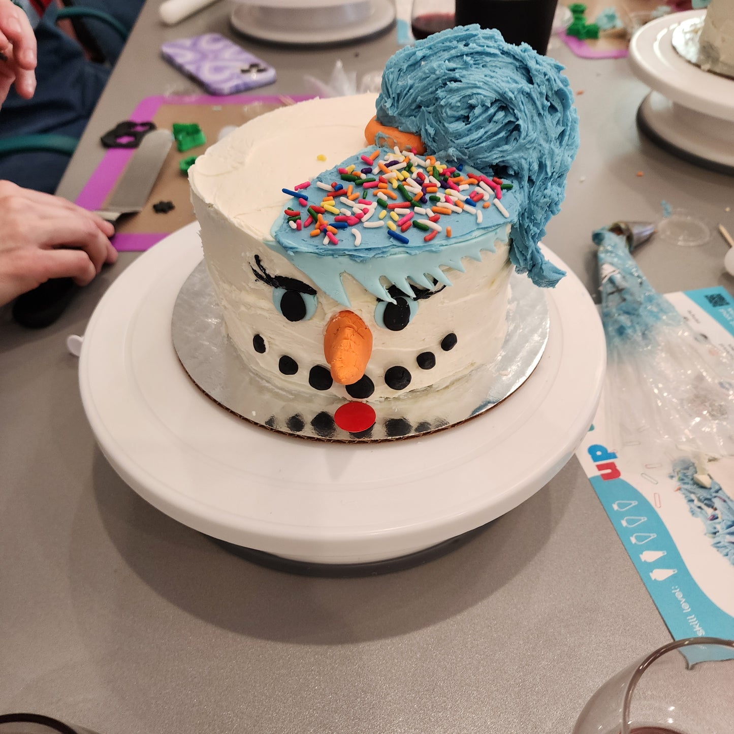 A unique snowwoman cake decorated during open studio time at Cake Hoopla in Tigard, Oregon near Portland.