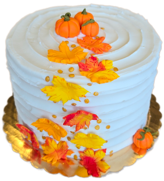 DIY cake by Cake Hoopla in Tigard, near Portland, with autumn-themed decorations including pumpkins and cascading leaves on a white background.