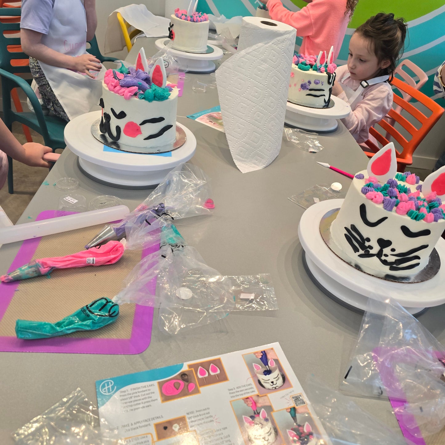 Kids turn cakes into cats with a DIY cake-decorating kit "Make Me Right Meow" at Cake Hoopla during open studio time in Tigard, near Portland.