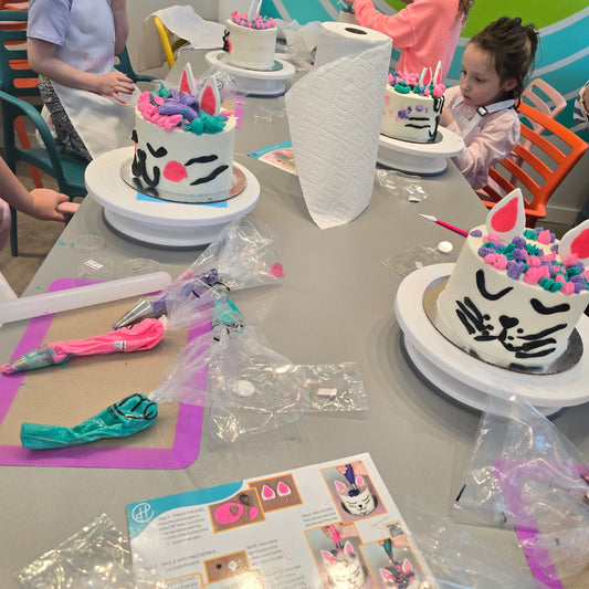 Kids turn cakes into cats with a DIY cake-decorating kit "Make Me Right Meow" at Cake Hoopla during open studio time in Tigard, near Portland.