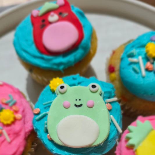 Squishmallow cupcakes and frosting, sprinkles, fondants, and tools used to create them for a DIY cupcake-decorating event at Cake Hoopla in Tigard, near Portland.