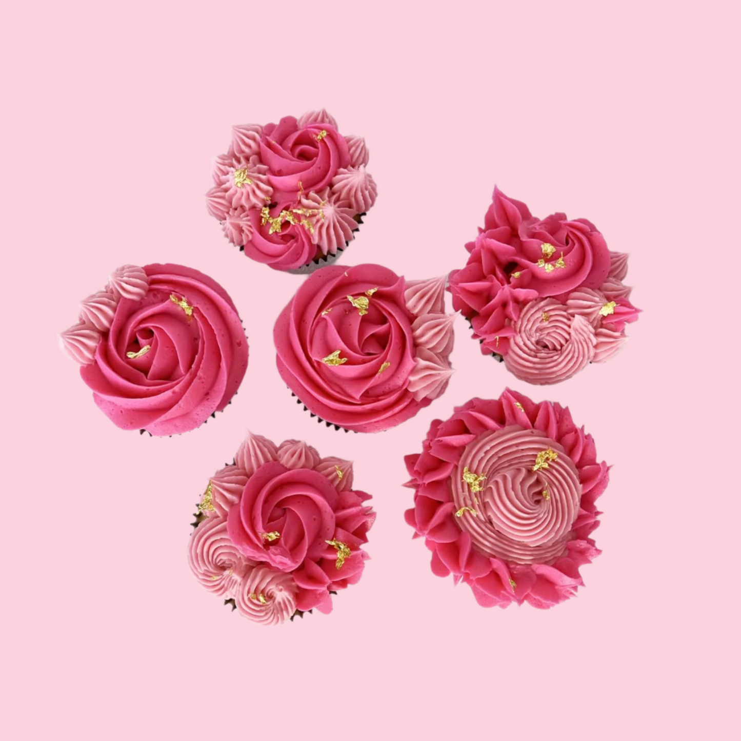 Finished cupcakes from the La Fleur DIY cupcake-decorating frosted with bright pink and light pink rosettes, pointy stars, and little swirls. Small amounts of gold leaf highlight each cupcake. Available as a cake kit during open studio time and to go and as pre-decorated cupcake from Cake Hoopla in Tigard, Oregon near Portland.