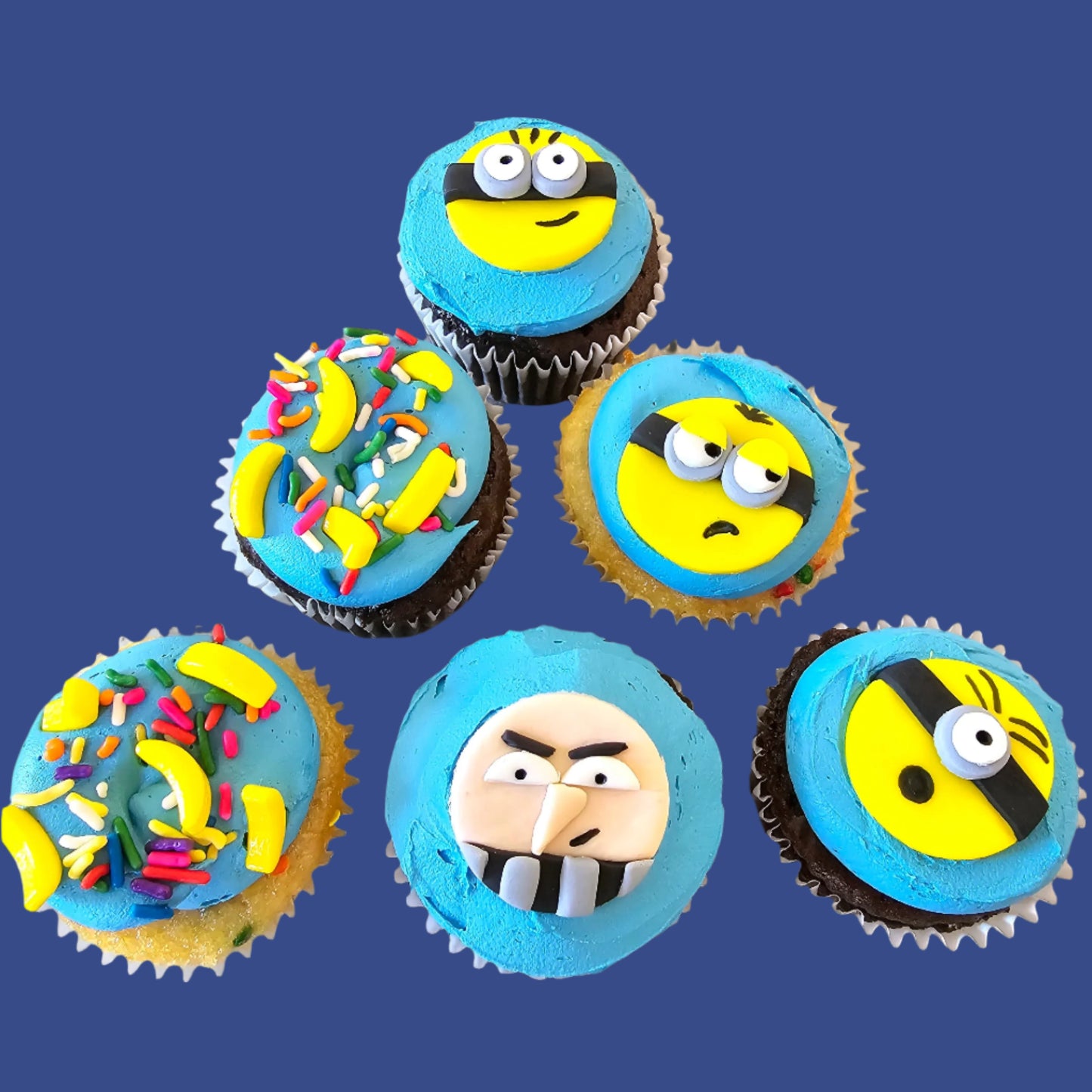 Minion Cupcakes with the faces of three minions and Gru, plus banana sprinkles, available by customer order at Cake Hoopla in Tigard, near Portland.