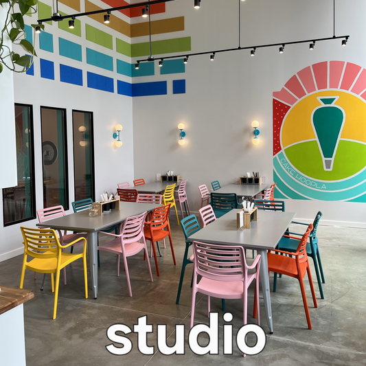 Cake Hoopla's bright, colorful, and fun general seating area in the studio in Tigard near Portland, available to rent with the party room for larger DIY cake/cupcake-decorating parties and events.