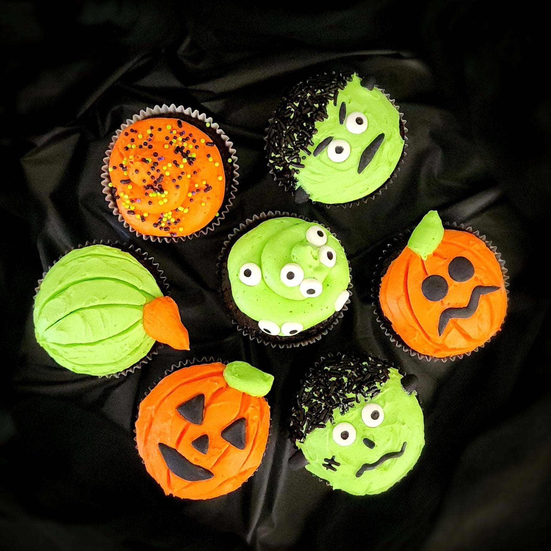 Halloween themed cupcakes with monster blobs, Frankenstein, and Jack O'Lanterns made during open studio time at Cake Hoopla in Tigard, Oregon near Portland.