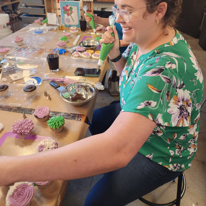 A woman decorates DIY flower cupcakes at a Cake Hoopla class in Tigard, Oregon, near Portland.