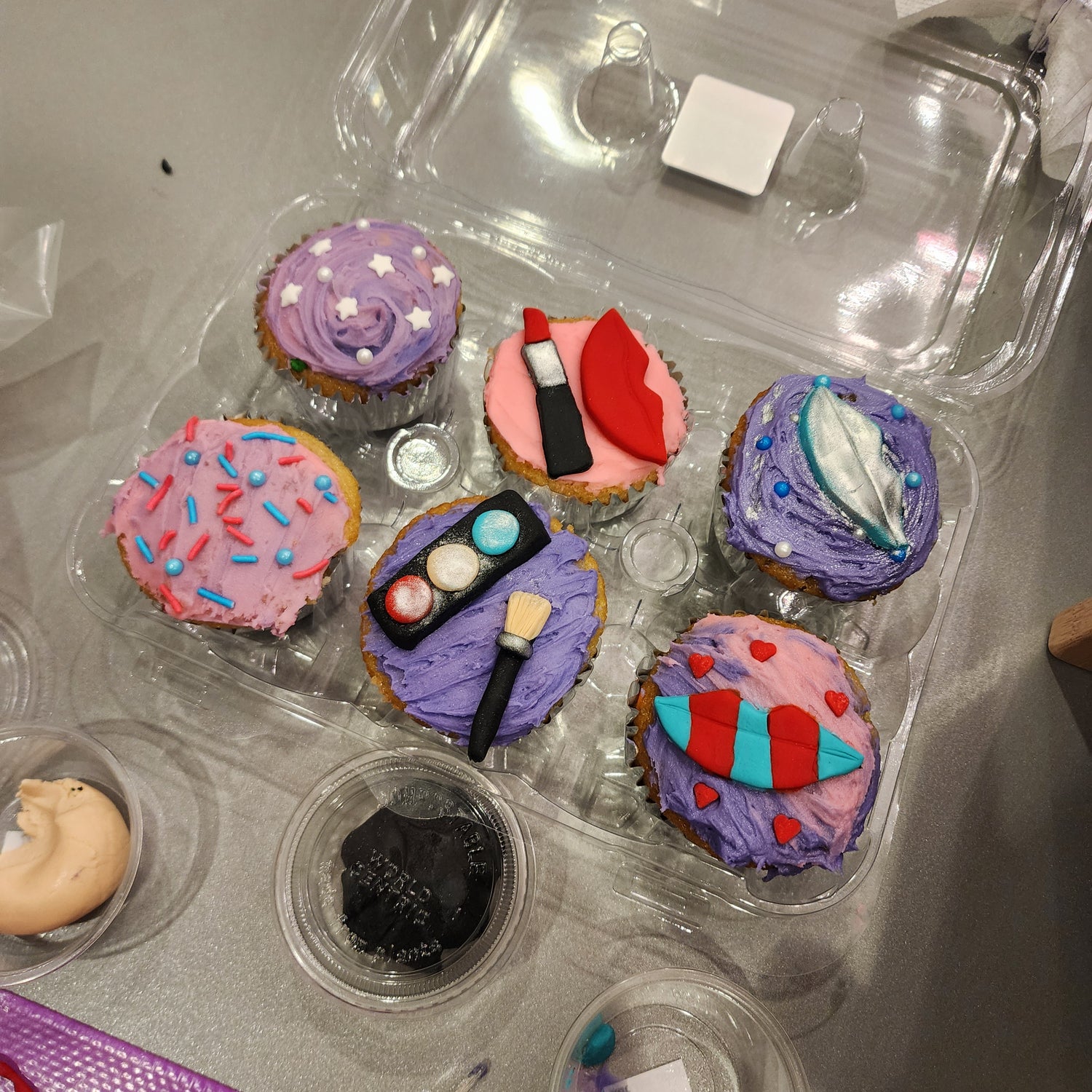 Six cupcakes decorated in a makeup theme during a Bespoke cupcake-decorating party at Cake Hoopla in the Portland area.