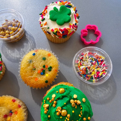 St. Patrick Day themed cupcake kit with white and green frosting, gold and rainbow sprinkles, green fondant, and a shamrock fondant cutter, available at Cake Hoopla in Tigard, Oregon near Portland, during open studio time for DIY cupcake decorating.