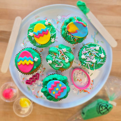 Bright, springtime DIY cupcake-decorating kit with Easter eggs made of fondant, pink, blue, and yellow fondant, fondant cutters, and a bunny sprinkle mix, available during open studio time at Cake Hoopla in Tigard, OR near Portland.