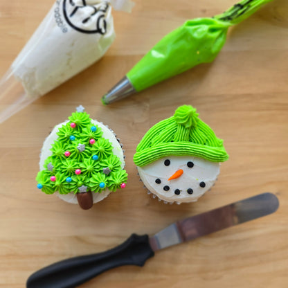 Colorful snowperson cupcakes and Christmas trees decorated at Cake Hoopla's DIY cake/cupcake-decorating event in Tigard, Oregon near Portland.