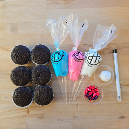 The components of the Friendship Bracelet DIY cupcake-decorating kit, including 6 cupcakes, 3 frostings, sprinkles, fondant, and an edible black marker, available at Cake Hoopla in Tigard, Oregon near Portland, during open studio time, for parties.