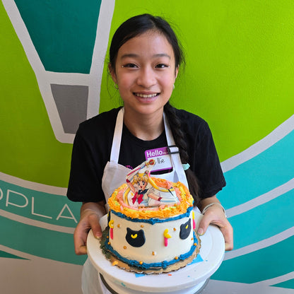 Person holding a cake with colorful decorations against a colorful mural.