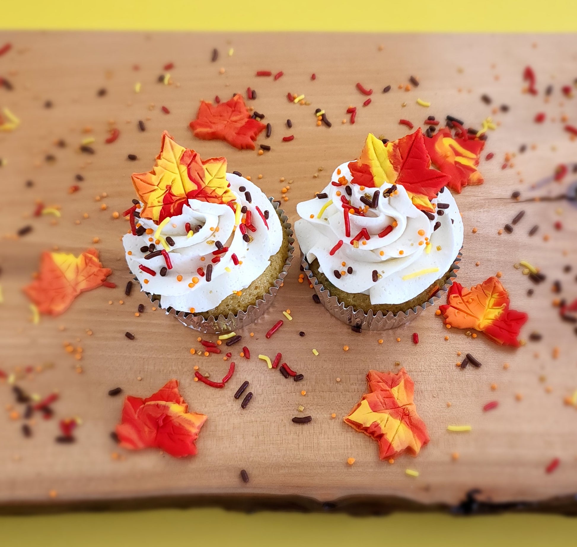 Fall-themed cupcakes with orange, yellow, and maple leaves available at Cake Hoopla in the Portland area.