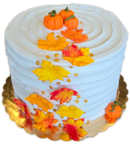 DIY cake by Cake Hoopla in Tigard, near Portland, with autumn-themed decorations including pumpkins and cascading leaves on a white background.