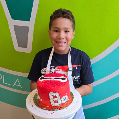 Boy proudly shows off his Big Hero 6 cake made during Cake Hoopla's summer cake camp.