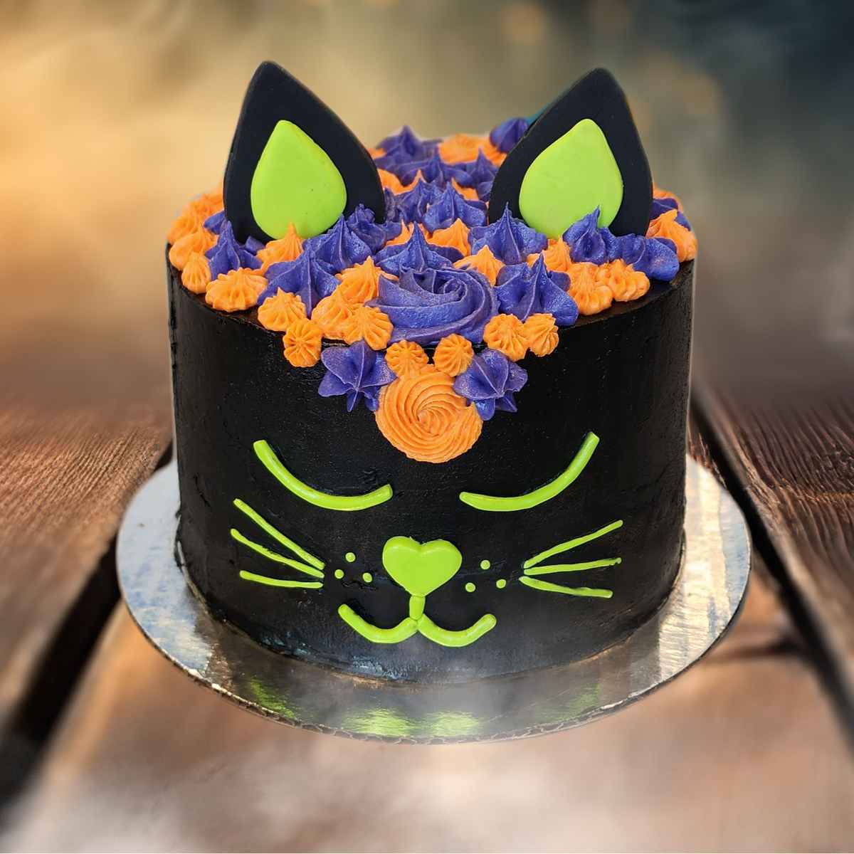 Halloween cake decorated like a black cat with colorful frosting available for DIY cake decorating during open studio time in Tigard, Oregon, near Portland, or through shipping or pickup