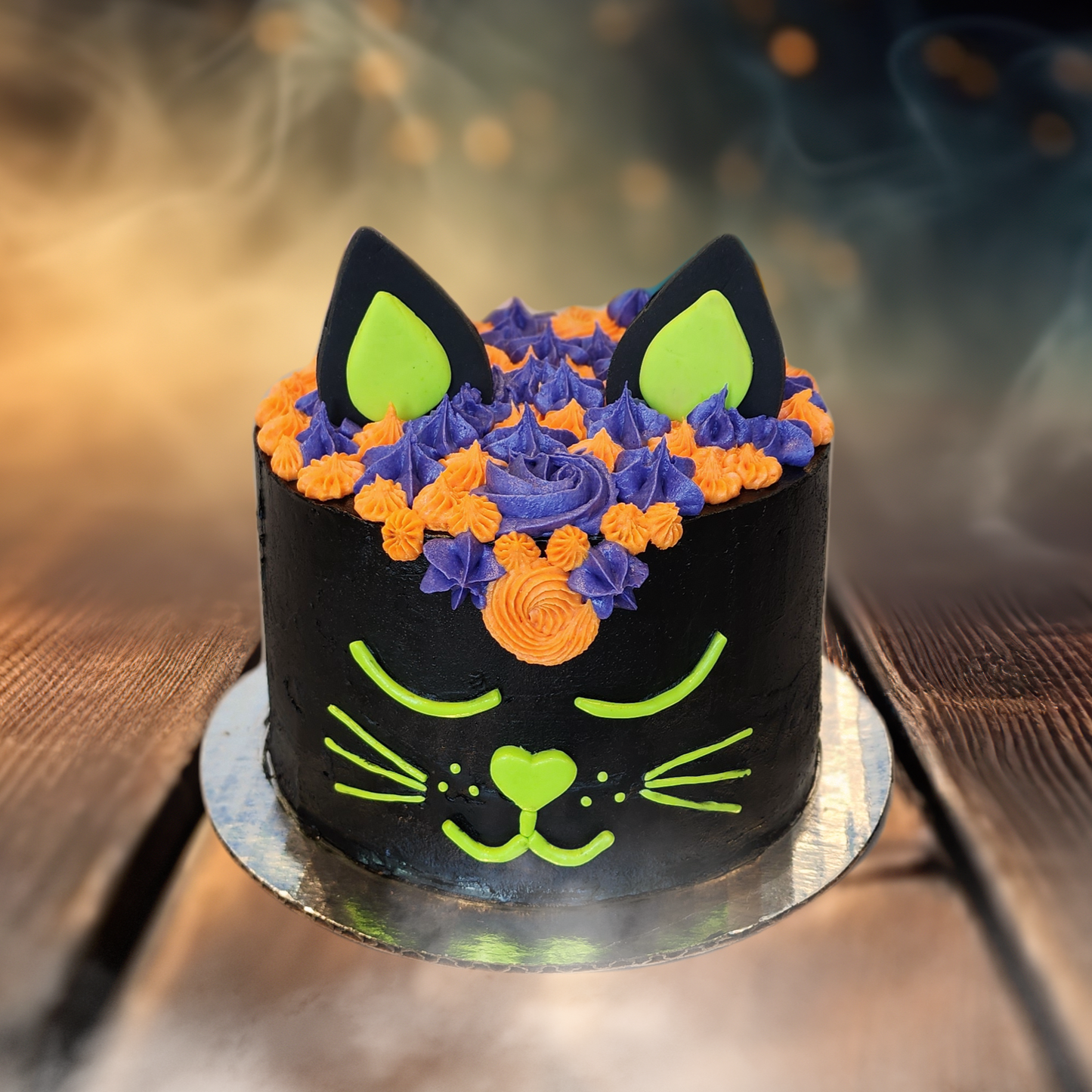 Halloween cake decorated like a black cat with colorful frosting available for DIY cake decorating during open studio time in Tigard, Oregon 