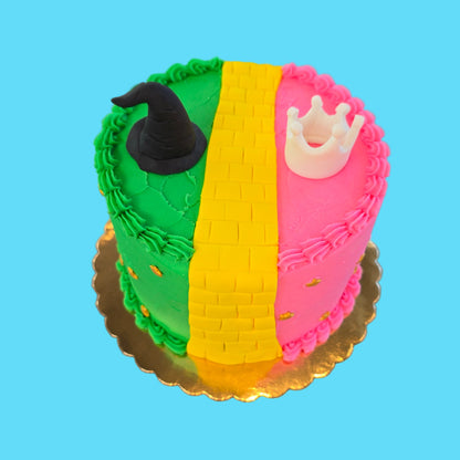 Wicked-themed cake made during cake-decorating class at Cake Hoopla in Tigard near Portland, with pink and green frosting, yellow brick road, and tiara and witches hat.