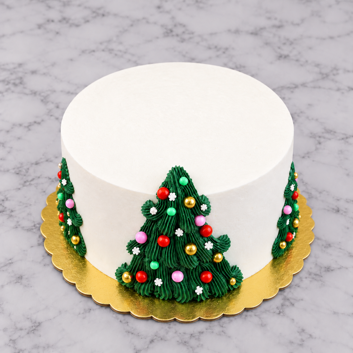 White round cake with dark green frosting Christmas trees piped on the sides of the cake with colorful sprinkle ornaments, on a gold cake board. 