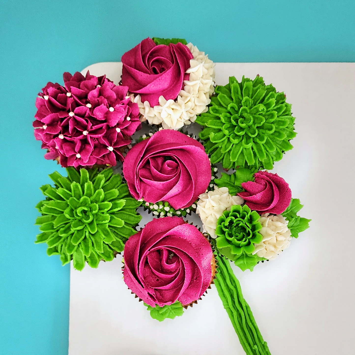 Colorful pink and green frosting flowers created at DIY cake-decorating class at Cake Hoopla in Tigard, near Portland.