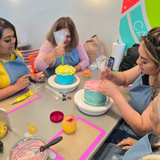 A group of women decorate floral-inspired cakes and sip mimosas at a DIY cake-decorating event at Cake Hoopla in Tigard, near Portland.