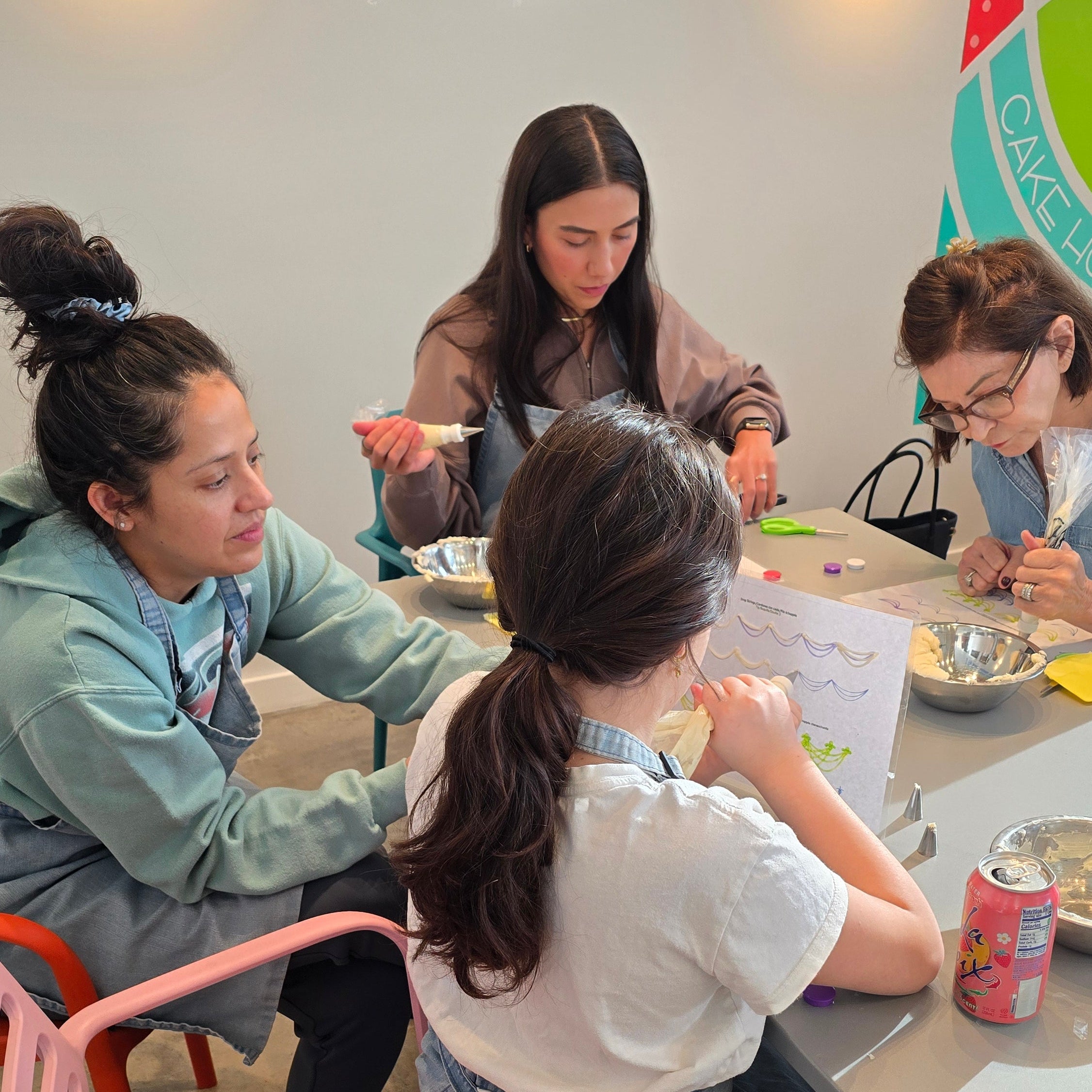 Group of students taking a cake-decorating class at Cake Hoopla in Tigard near Portland.