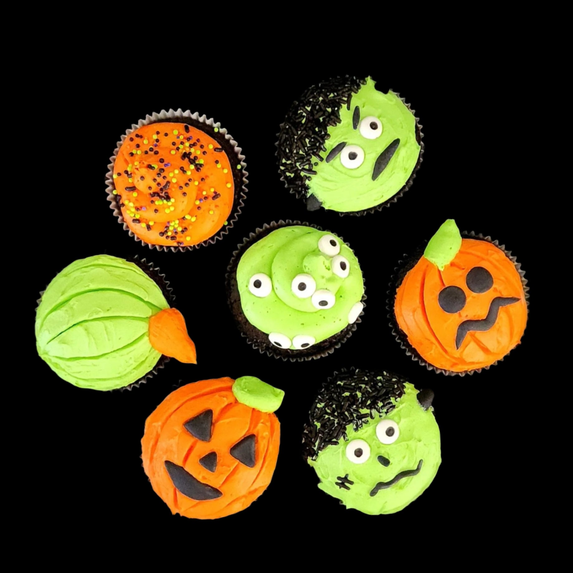 Halloween themed cupcakes with monster blobs, Frankenstein, and Jack O'Lanterns made during open studio time at Cake Hoopla in Tigard, Oregon near Portland.