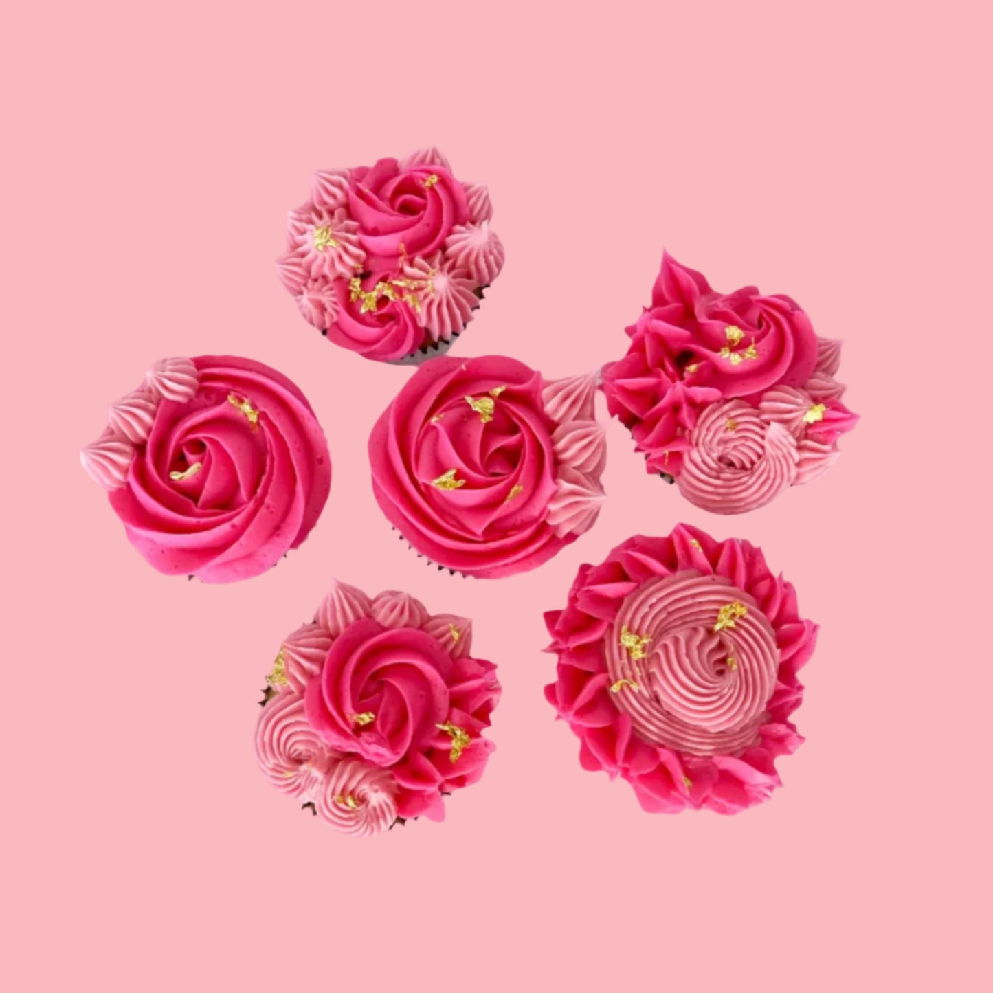 Pink floral-themed cupcakes decorated with light and dark pink rosettes and stars and gold leaf; a DIY cupcake kit available to decorate during open studio time at Cake Hoopla in Tigard, Oregon, in the Portland area.