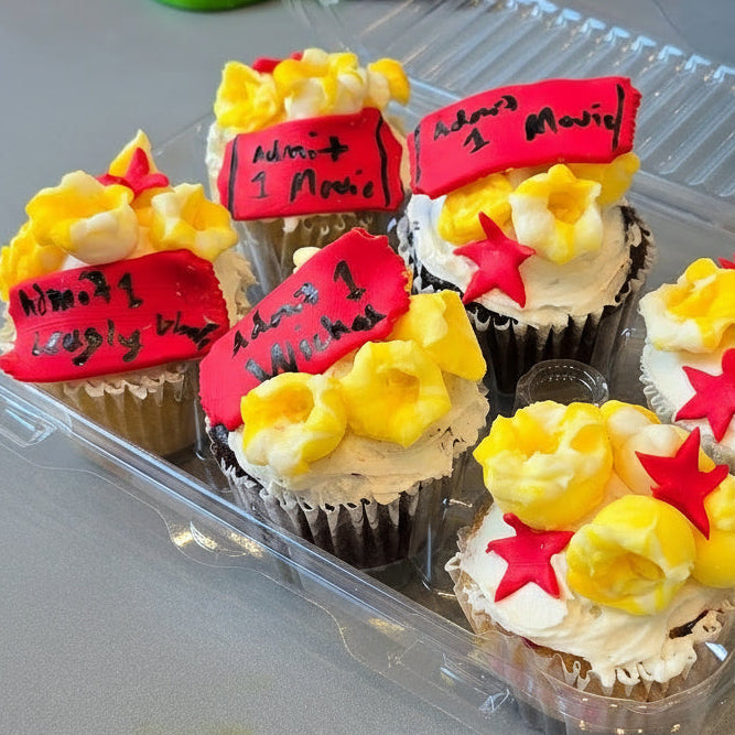 Cupcakes decorated with popcorn-looking frosting and fondant movie tickets at Cake Hoopla's summer cake camp.