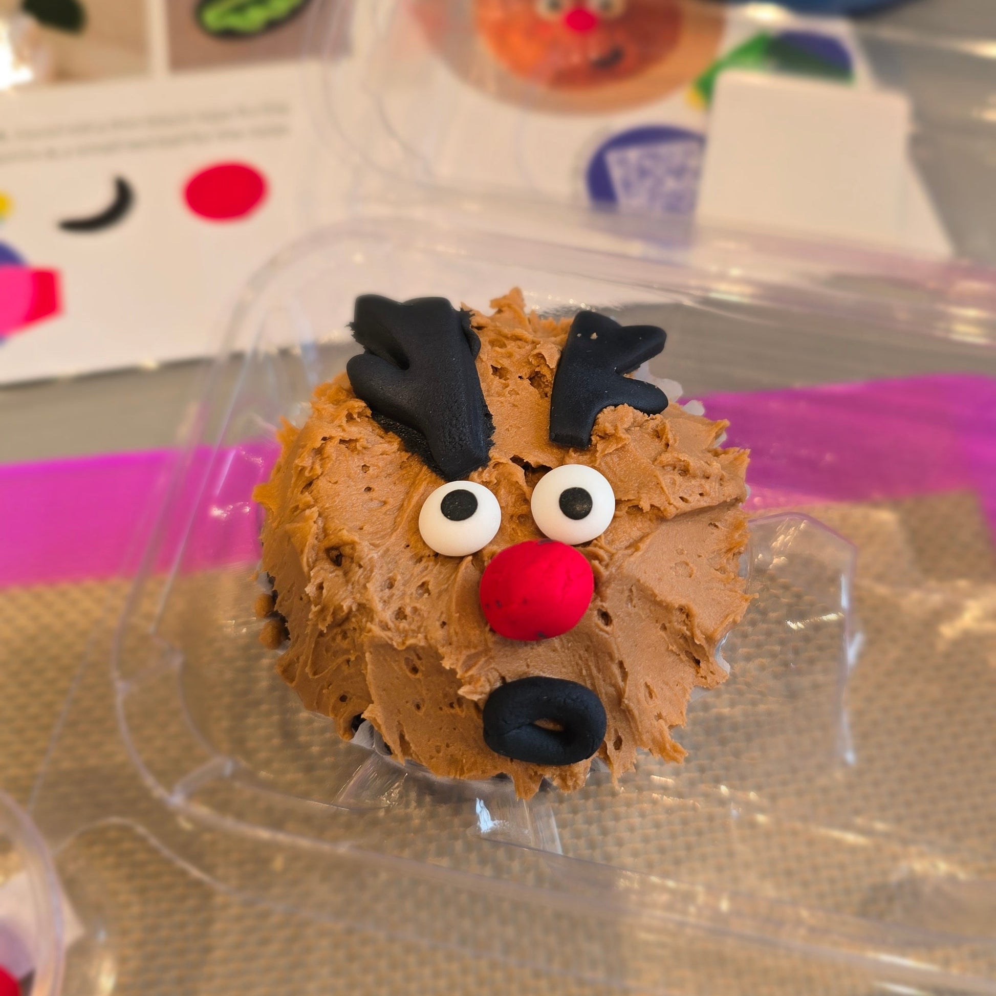 Rudolf Cupcake with brown frosting, red nose, and black antler decorated at Cake Hoopla in Tigard, near Portland.