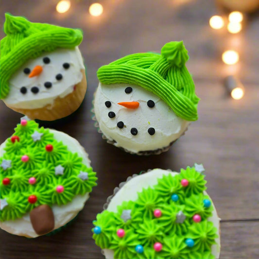 Colorful snowperson cupcakes and Christmas trees decorated at Cake Hoopla's DIY cake/cupcake-decorating event in Tigard, Oregon near Portland.