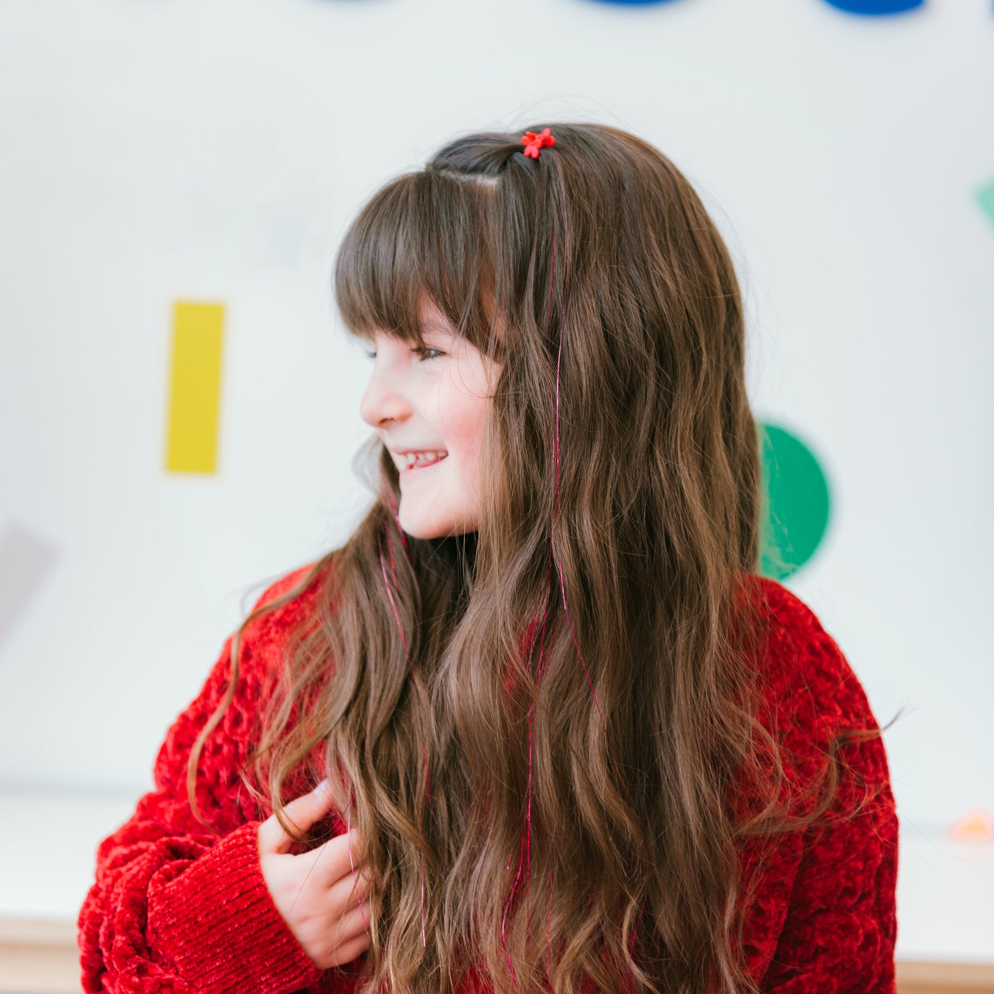 A girl with long hair shows off several sparkle strands by Sit Still Salon in Portland.