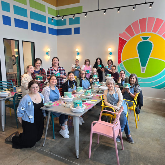 A group of women show off their beautiful bird-themed cakes decorating during a DIY cake-decorating teambuilding event at Cake Hoopla in Tigard, near Portland.
