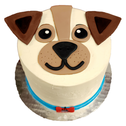 A white dog-face cake with brown features and a blue collar made during a DIY cake-decorating workshop