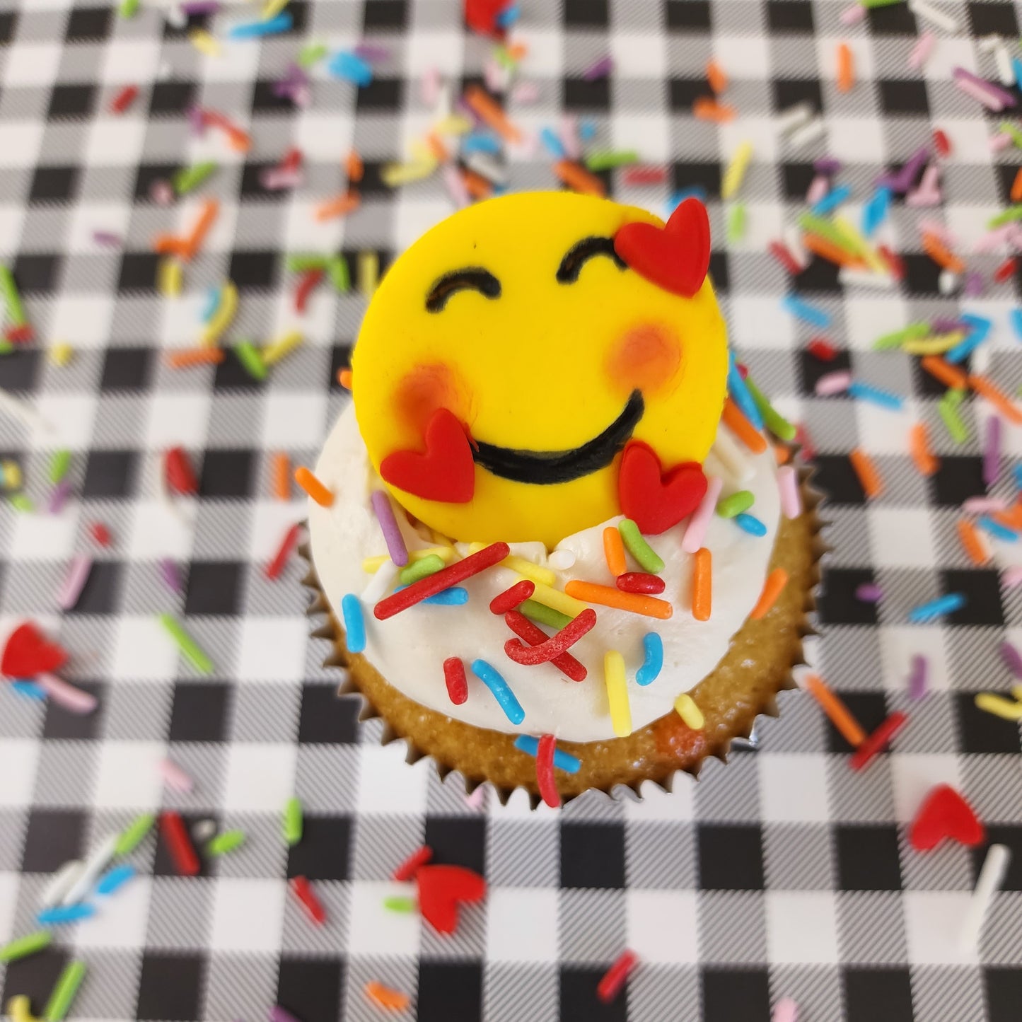One emoji DIY cupcake from DIY decorating kit. Grateful, thankful, bashful emoji.
