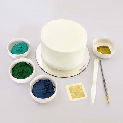 Picture of the Classy as Fine Gold cake kit before decorating, including frosting, gold accents, and tools, available during  time at Cake Hoopla in Tigard, Oregon.