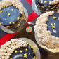4 star-spangled moon cakes decorated after a DIY cake decorating party.